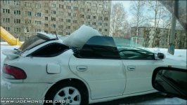subaru with ice brick at top of a roof.jpg